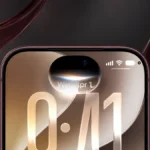 iPhone с интерфейсом iOS 27 в студии с бордовыми стеклянными элементами